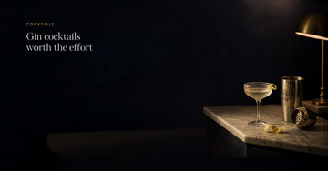 A coupe glass, lemon twist and shaker on a marble counter at night — Gin cocktails worth the effort