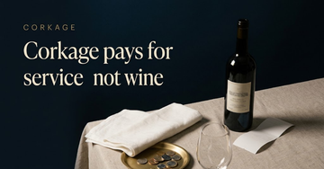 A wine bottle beside a blank receipt turned face down, a wine glass, a folded white napkin and a small tray of coins — Corkage pays for service not wine