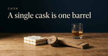 A short stack of mahjong tiles beside a single oak cask bung and stave, one filled whisky glass standing alone — A single cask is one barrel