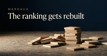 Loose wooden classification tiles scattered and half stacked on a stone table, one pile forming again beside the fallen others — The ranking gets rebuilt