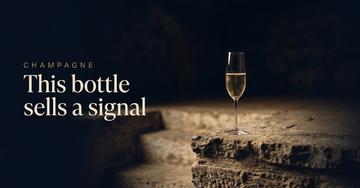 A single champagne flute catching candlelight on a stone ledge above a chalk cellar stair, the room beyond empty — This bottle sells a signal