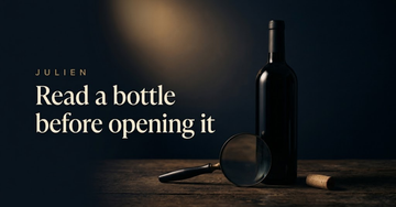 An unopened bottle silhouetted in candlelight beside a magnifying glass and a loose cork on dark cellar wood — Read a bottle before opening it