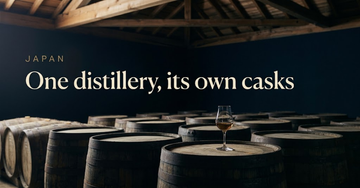 Neat rows of dark oak whisky casks stacked beneath a wooden warehouse roof, a single dram glass resting on a barrel head — One distillery, its own casks